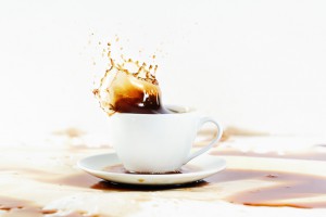 10694714 Cup of coffee creating splash White background coffee s