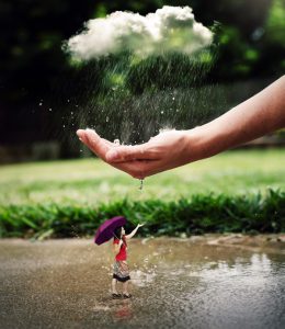 a-woman-in-a-rain-shower-is-being-protected-by-a-large-hand_bqg6xjglc-600